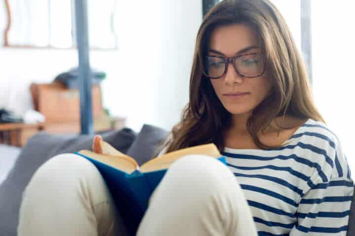 woman reading book home cozy