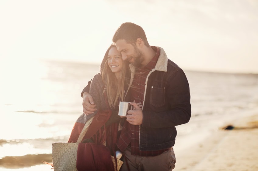 Photo of a lovely couple walking on the beach