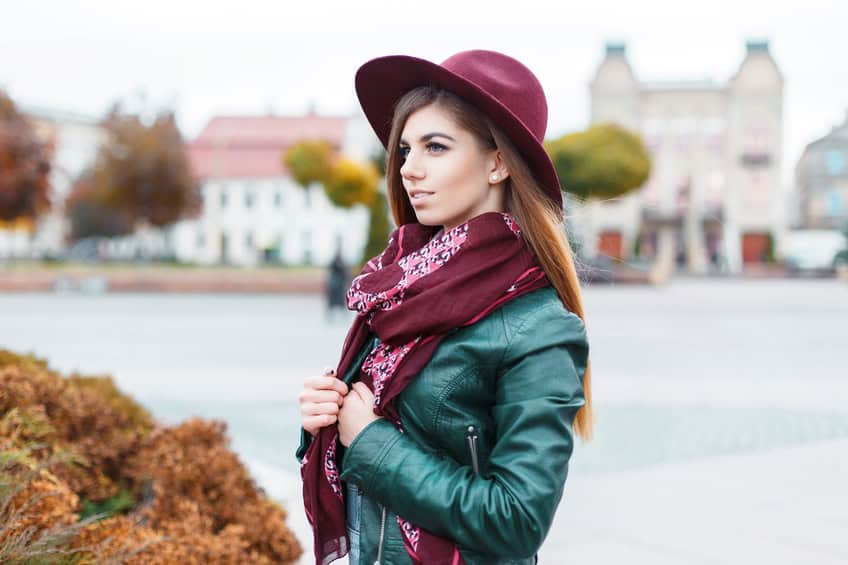 Beautiful fashionable woman in a hat and scarf posing