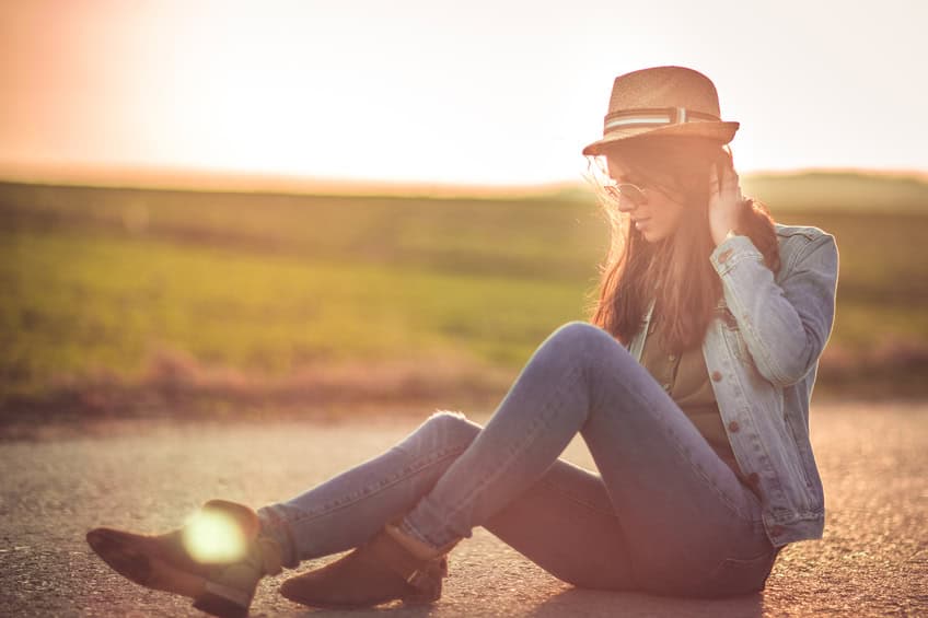 Beautiful girl on rural road in nature