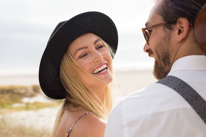 couple laughing happy beach romance sunset