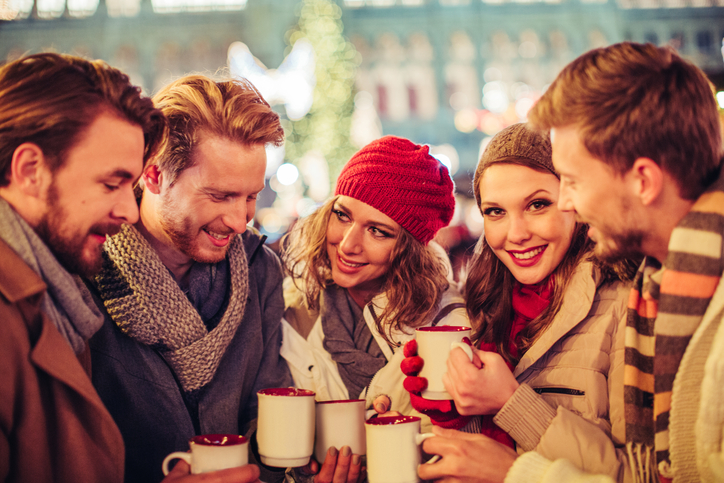Young group of friends visiting Christmas market in Vienna, Austria.