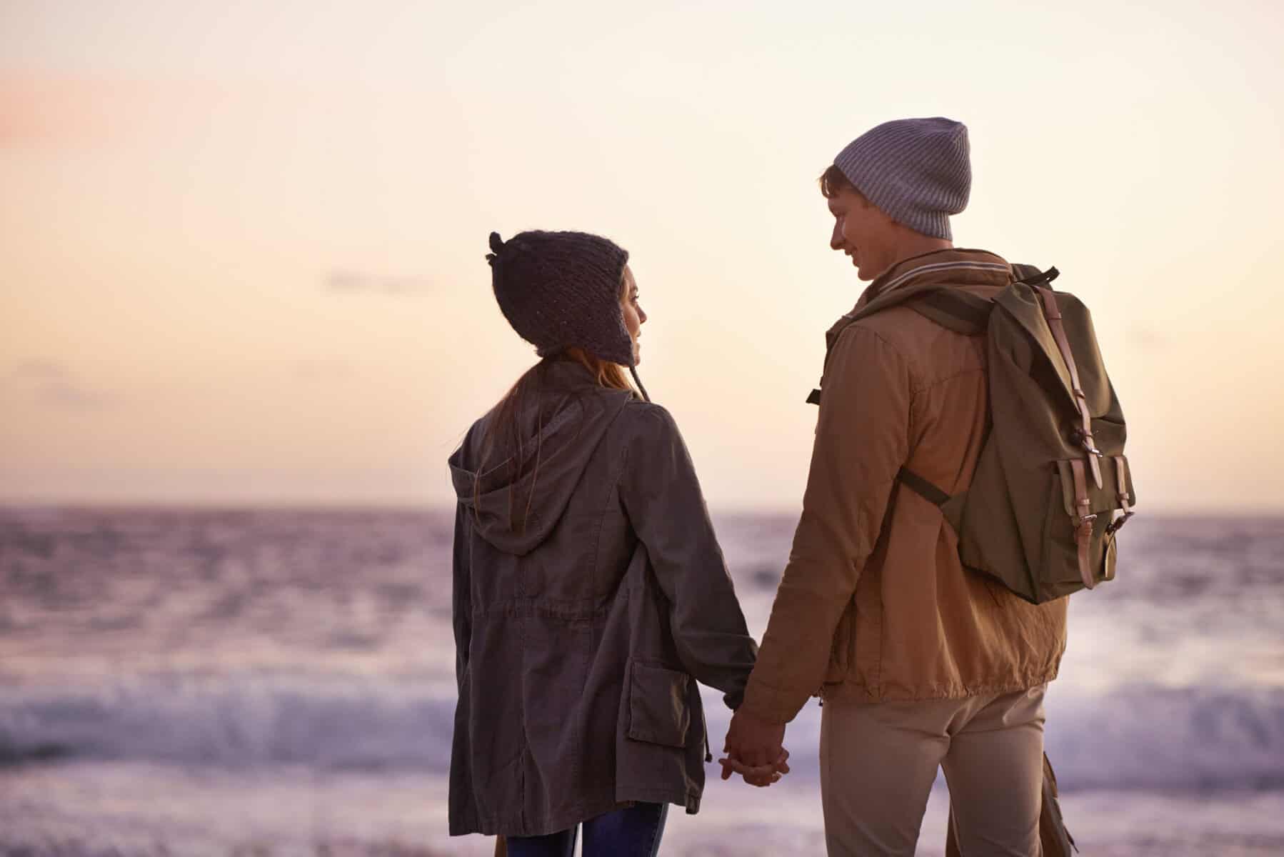Shot of a young couple enjoying a romantic evening on the beach at sunset