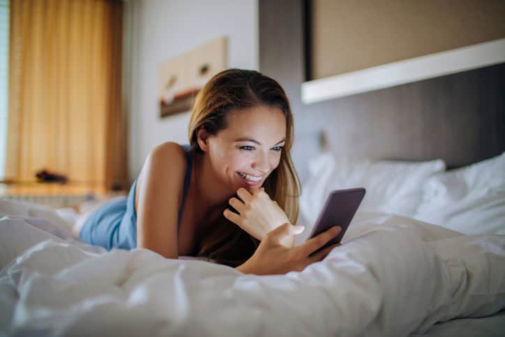 Close up photo of a young woman using a smart phone