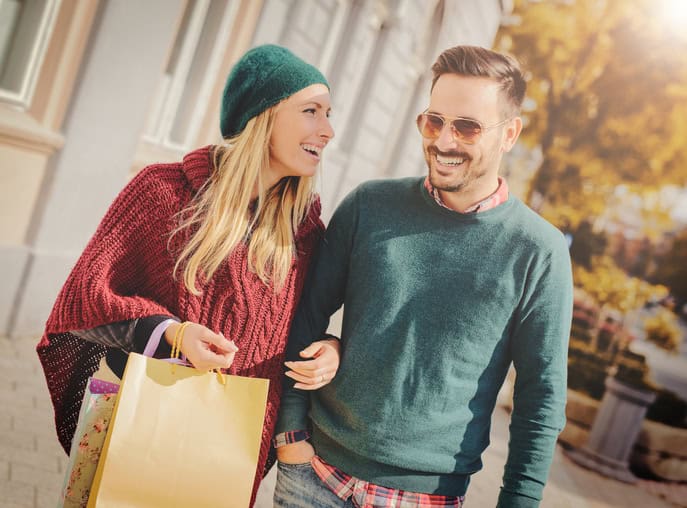 Young happy couple with shopping bags in the city