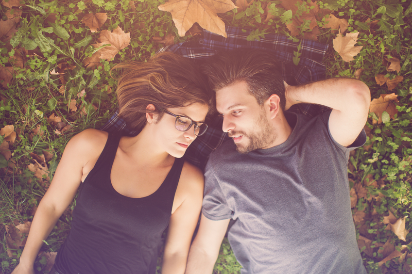 Happy couple lying on the grass