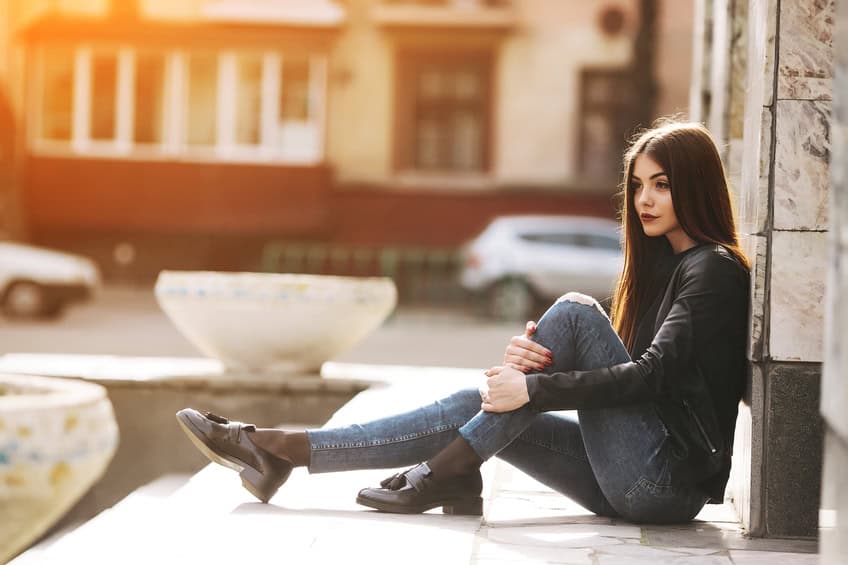 Young adult woman posing on a city street