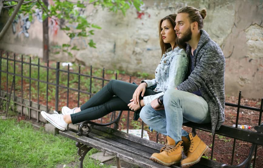 Couple sitting on bench and resting.