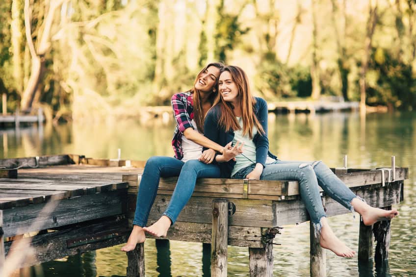 Young women sitting on the pier