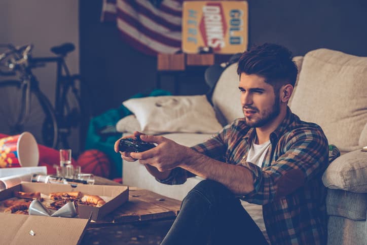 Man playing video games on the floor.