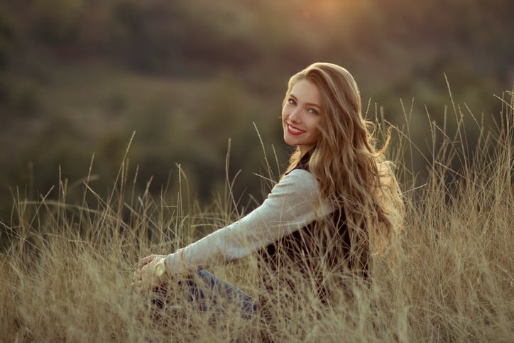 Smiling girl walking on a hill with a very beautiful view.