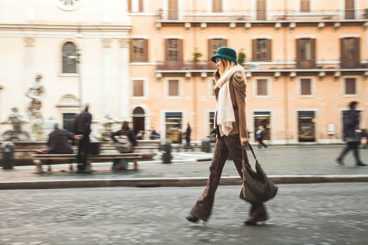 Portrait of a young woman walking in the city streets, Rome, Piazza Navona - Italy