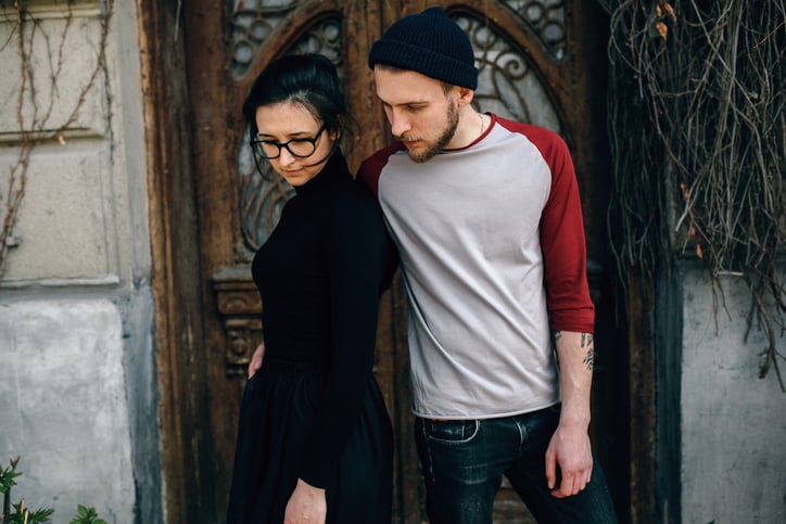 young beautiful couple posing on the background of an old building