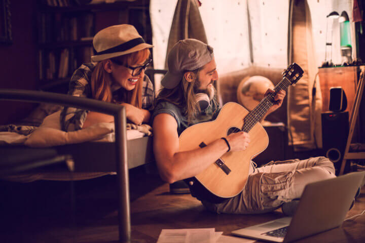 Man playing guitar with friends.