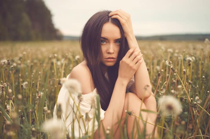 Outdoors art photo of beautiful lady in dandelions field