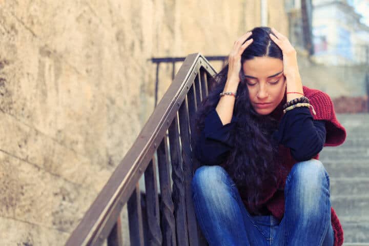 Sad Woman on the Street Closes Eyes