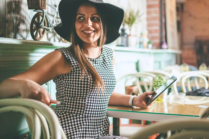 happy smiling young woman using digital tablet indoor