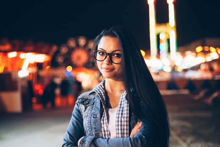 Portrait of beautiful asian woman with eyeglasses in amusement park