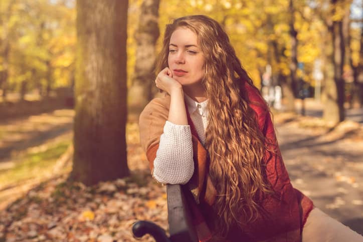 Woman thinking park bench