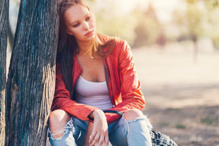 Thoughtful woman in the city park