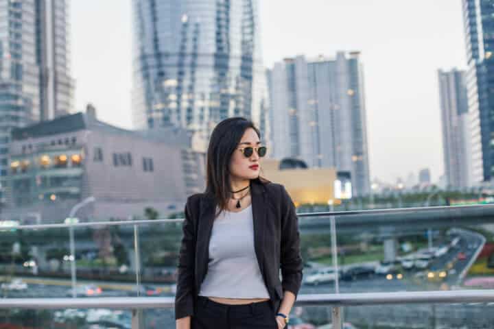 Beautiful businesswoman enjoying the sunny day outside of the office, in downtown.