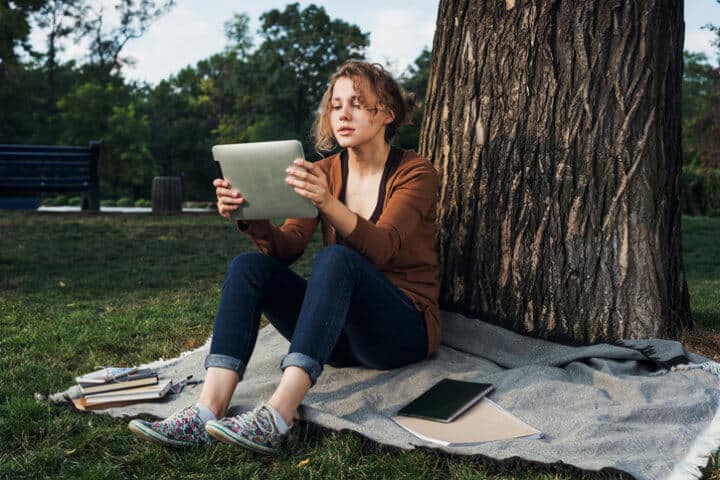 young female student with tablet on campus.