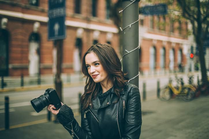 young woman happy camera outdoors city