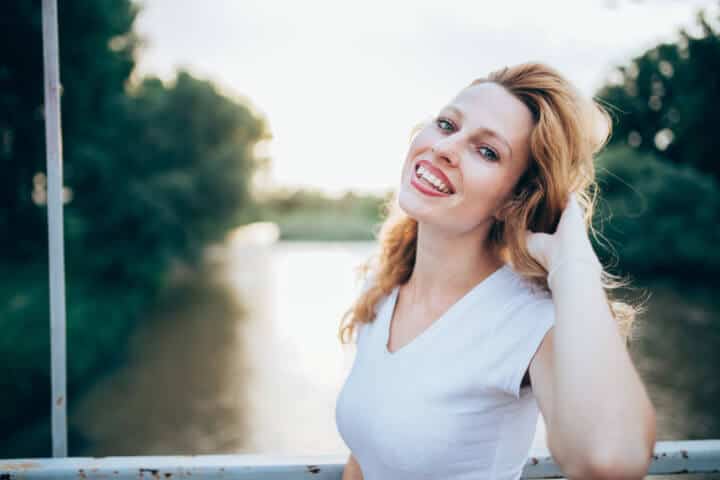 Beautiful smiling woman leaning at handrails