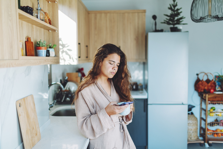 woman reading text with morning coffee