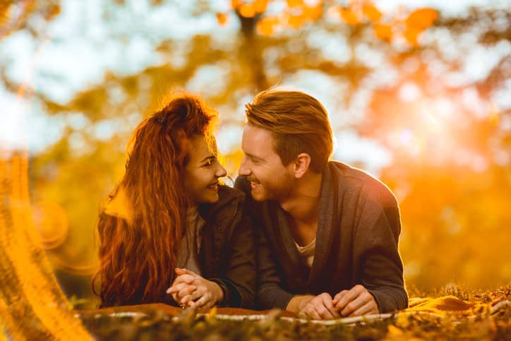Happy romantic couple enjoying in autumn day outdoors.