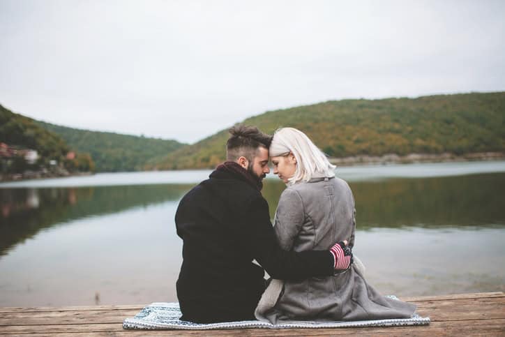 Lovely couple on jetty in the lake