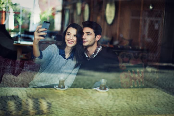 young couple cafe selfie