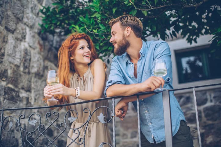 couple leaning over a balcony together