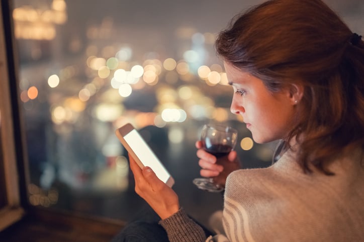 Woman in the window on her smartphone.