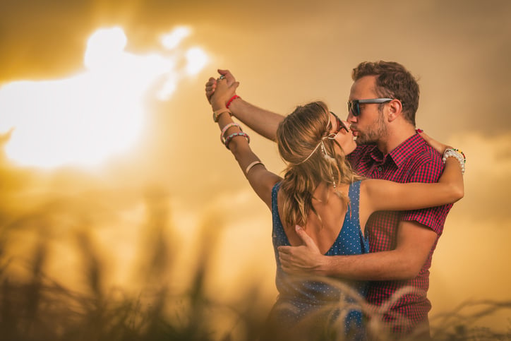 Couple enjoying outdoors in a wheat field.