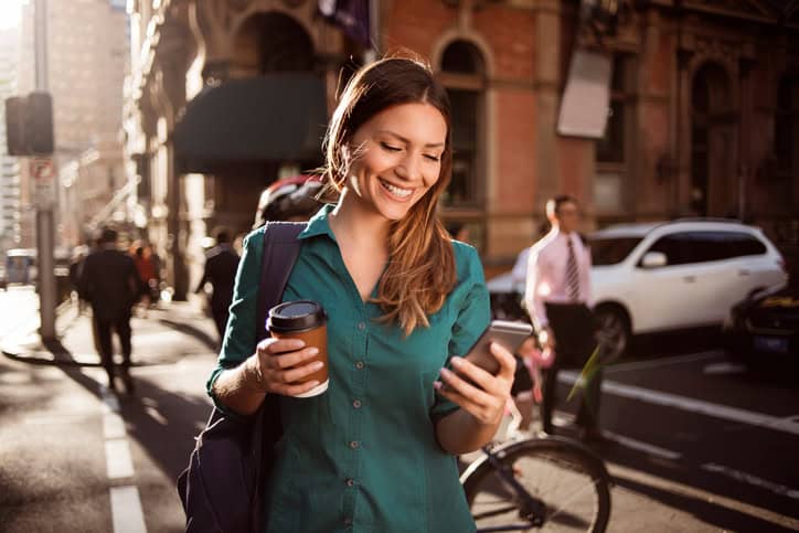 Young woman using smartphone in the street
