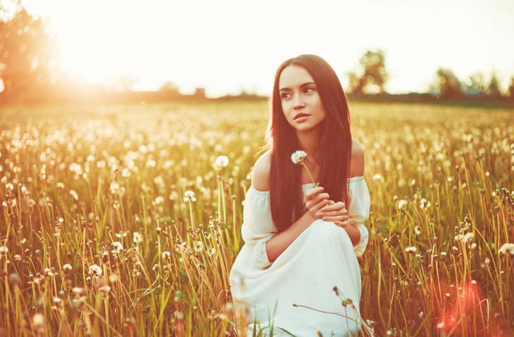 Outdoors art photo of beautiful lady in dandelions field