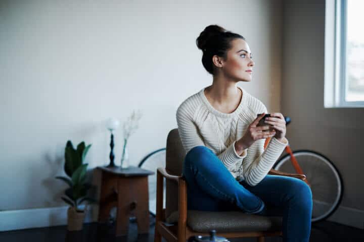 Shot of a young woman having coffee at home