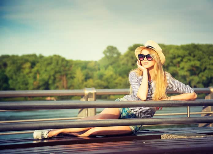Portrait of Young Hipster Woman Relaxing in Park. Modern Youth Lifestyle Concept. Toned Photo.