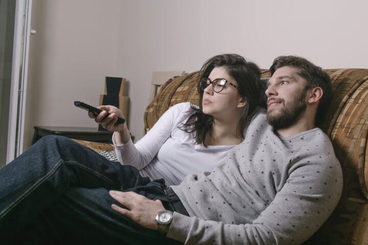 young couple couch tv date romance