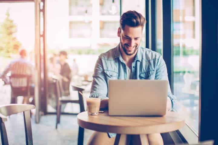 Young man cafe laptop