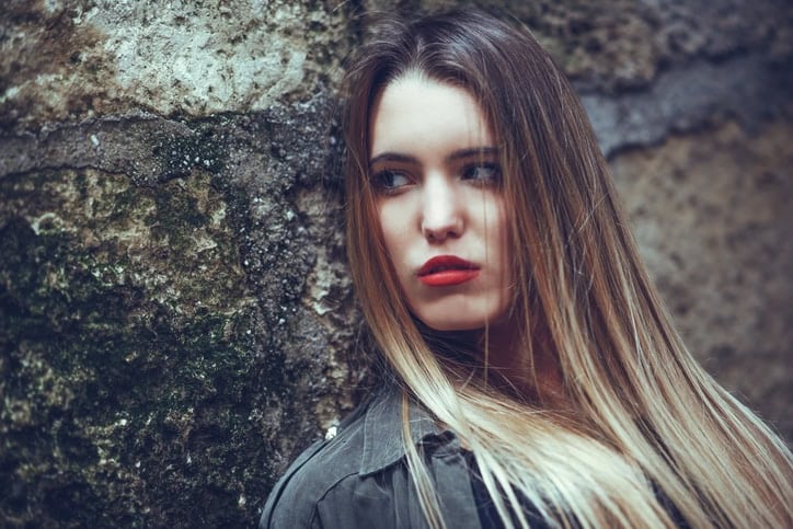 Brunette woman against wall