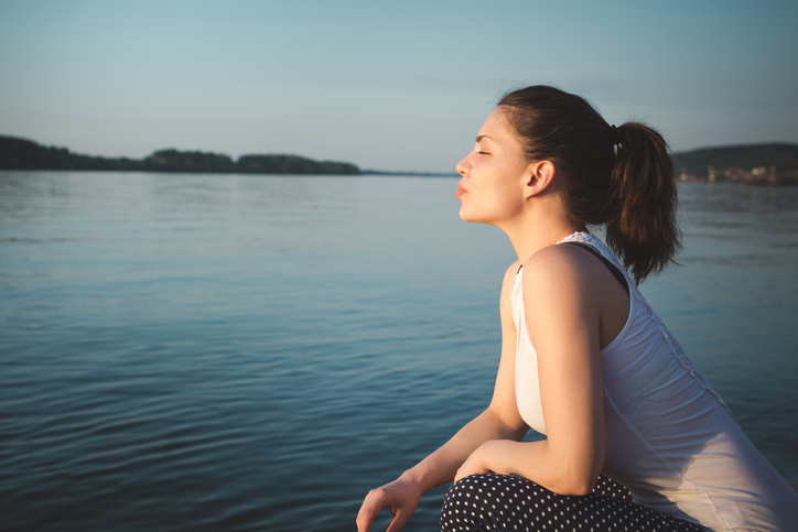 A Beautiful Girl Enjoying Summer Sun on the coast.