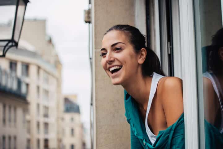 Beautiful young woman looking outside the window, with copy space. Shot made during Istockalypse Paris 2016 event.