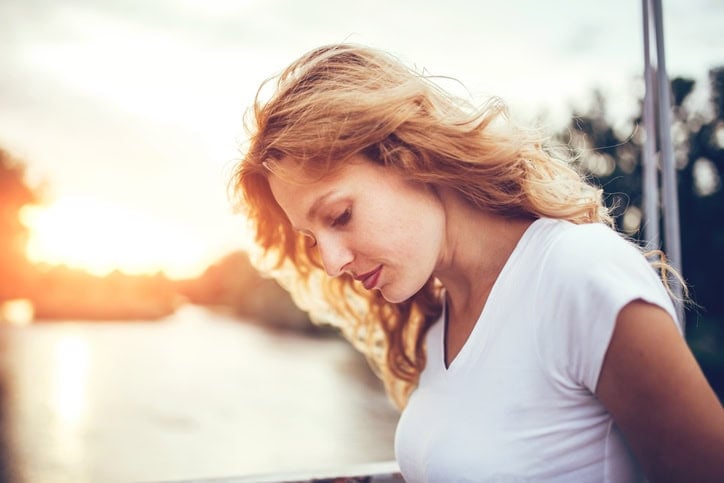 Beautiful young blond woman outdoors portrait near the lake