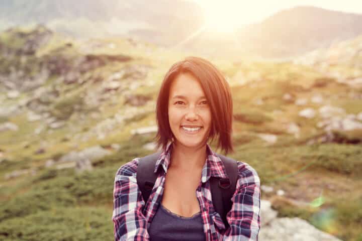 Tourist in the mountain smiling to the camera