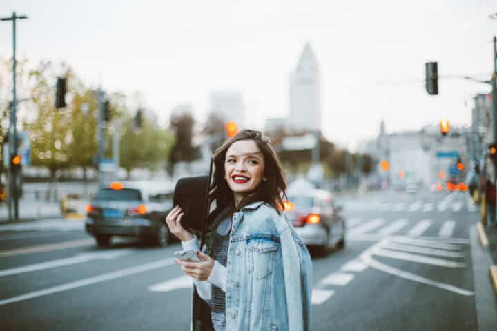 Stunning beautiful woman with red lipstick out in the city, on a lovely day.
