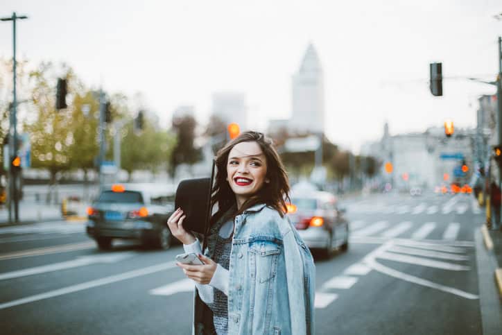 Stunning beautiful woman with red lipstick out in the city, on a lovely day.