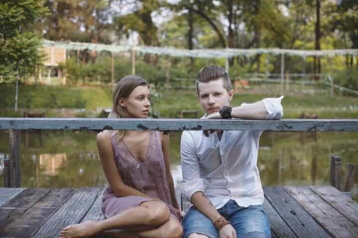 Young couple male and female together in outside in the park