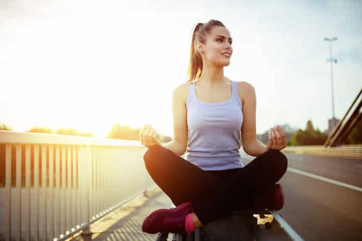 Woman relaxing next to a busy road, challenge concept